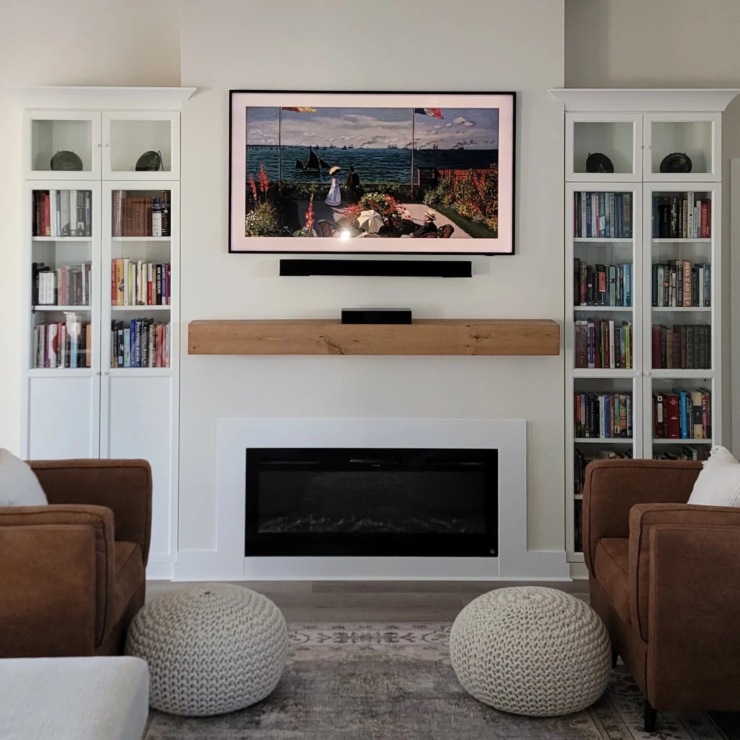Living room with white built-in bookcases, wood mantel and fireplace surround, built by Moss Maintenance